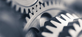 Close-up image of interlocking metal gears, representing precision, engineering, or seamless mechanical operation.
