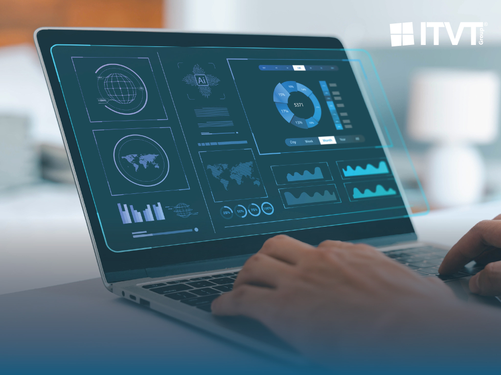Close-up of a laptop displaying a futuristic dashboard with charts, graphs, and world maps in shades of blue, suggesting data analysis and AI integration. A person's hands are typing on the keyboard. The ITVT Group logo is visible in the upper right corner. By ITVT.