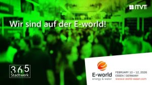 Promotional banner with a green‑tinted blurred crowd in the background. The text ‘Wir sind auf der E‑world!’ is displayed in white. The ITVT logo appears in the upper right corner, and the ‘365 Stadtwerk’ logo is on the lower left. At the bottom right, the E‑world energy & water logo is shown with event details: February 10–12, 2026, Essen, Germany, and the website www.e-world-essen.com.