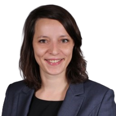 Professional portrait-style image of a person wearing a dark blazer and black top, used for ITVT corporate materials.