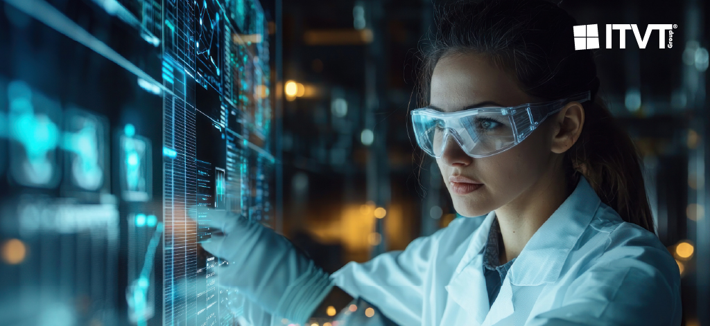Eine Frau in einem Laborkittel studiert einen Computerbildschirm und konzentriert sich auf ihre Arbeit in einem wissenschaftlichen Umfeld.